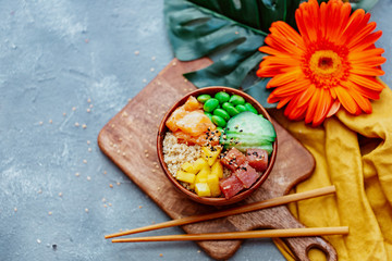 Raw Organic Ahi Tuna Poke Bowl with Rice and Veggies close-up on the table