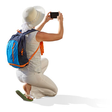 Female, girl, or woman tourist taking photo with phone or cellphone  isolated on white background including clipping path.