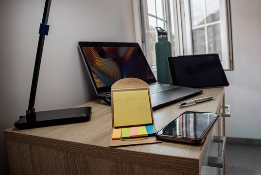 Desk with different things and a window