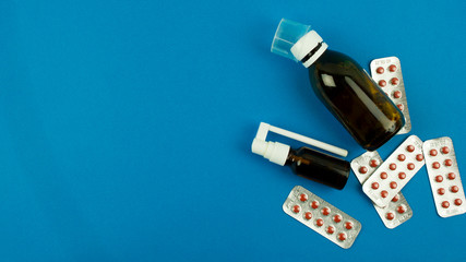 pills and medicines on a blue background, concept of medicine and healthcare health and treatment, place for text, top view