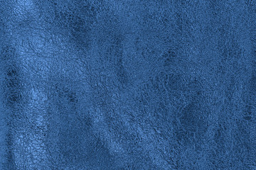 Texture of blue genuine crumpled leather with wrinkles, bright fashion background