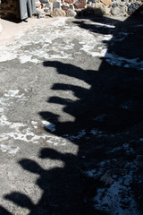 Shadows of a group of people against stone background