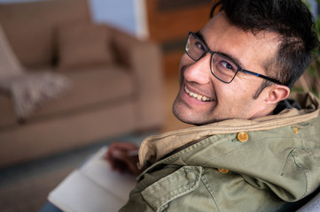 happy man with glasses writing