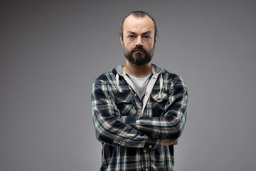 Front portrait of serious man with crossed arms