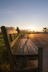 Fototapeta premium Spring day in the park. The rays of the sun fall on the benches