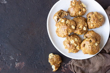 Soft and tender apple biscuits on a ceramic plate, dark concrete background. Dessert or breakfast for children, sweet snack. Selective focus.