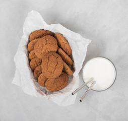 Oatmeal cookies in a box with milk top view