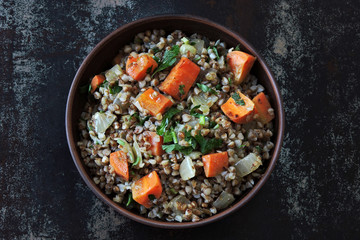 Buckwheat porridge with vegetables in a bowl. View from above. Dietary food. Quarantine food.