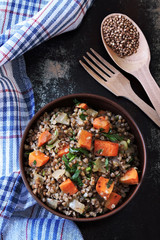 Buckwheat porridge with vegetables in a bowl. View from above. Dietary food. Quarantine food.