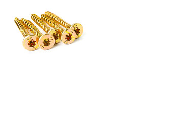 Gold screws scattered randomly on a white background. Torx yellow zinc head screws