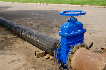 Fototapeta na wymiar a water valve on a pipe that drains excess water. sewer cleaning
