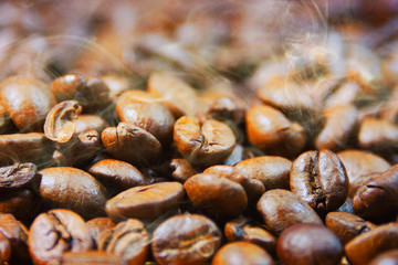 Coffee cup and beans on old kitchen table.
