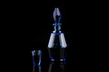 Blue crystal carafe. On black background.