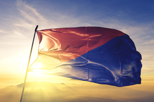 Riobamba of Ecuador flag waving on the top sunrise mist fog