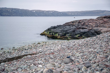 View of the stone beach and the sea. Barents Sea Kola Peninsula. Murmansk region is the north of...