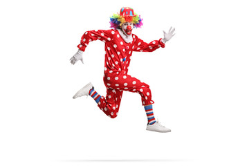 Clown in a polka dot red costume jumping