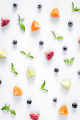 cut fruit pattern with blueberry and lavender on white desk background top view