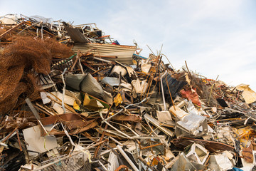A huge mountain of metal pieces of different origin accumulated in a scrap yard