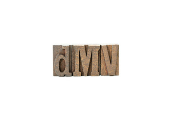 DMV in wood block letters