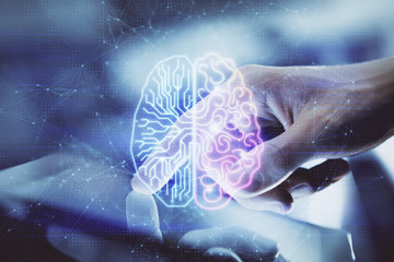 Double exposure of man's hand holding and using a digital device and brain hologram drawing. Data...