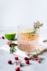 summer homemade juice with lime and berries on stone table background