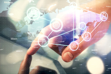 Double exposure of man's hands holding and using a phone and social network theme drawing.