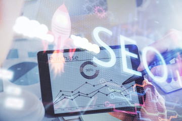 Multi exposure of man's hands holding and using a digital device and seo drawing. search...