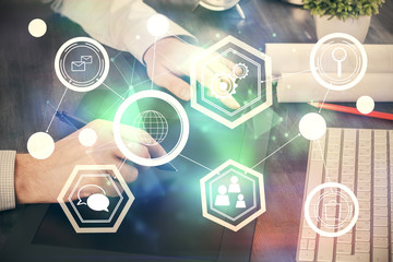 Double exposure of man's hands holding and using a phone and social network theme drawing.