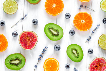 cut fruit design with blueberry and lavender on white background top view pattern