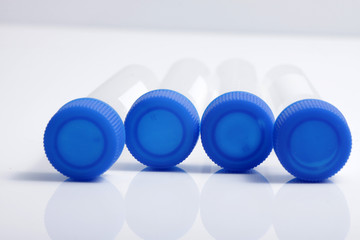 Close up shot of empty plastic test tube with blue lid for medical and laboratory testing purpose