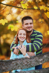 happy couple of lovers in the autumn forest