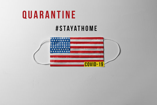Covid-19. Surgical mask with the United States flag showing the message "QUARANTINE"