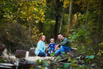 happy family in the autumn forest