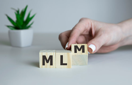 Wooden letters spelling MLM, business mlm concept.