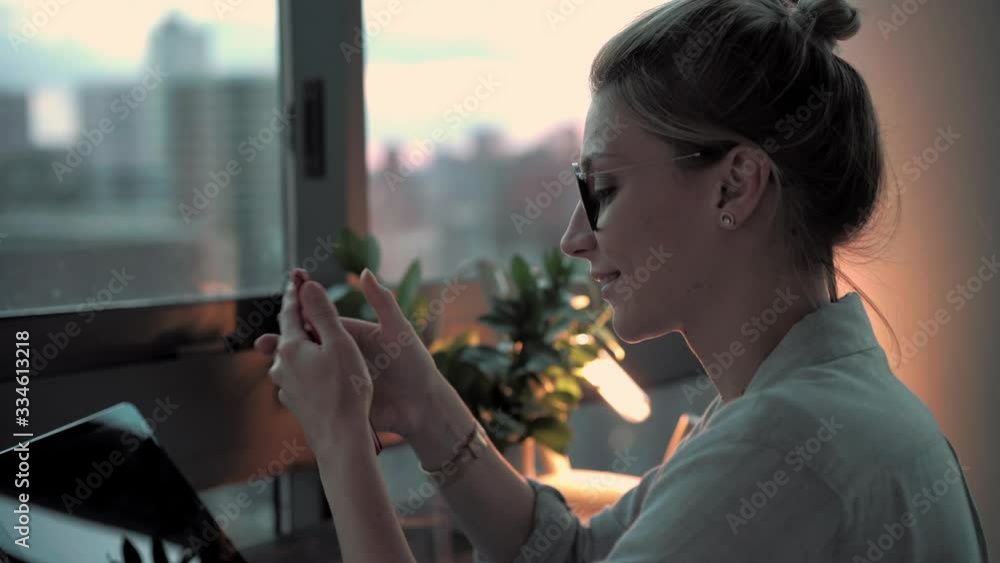 Aufkleber young caucasian woman using cellphone device for making mobile internet chatting during leisure indo