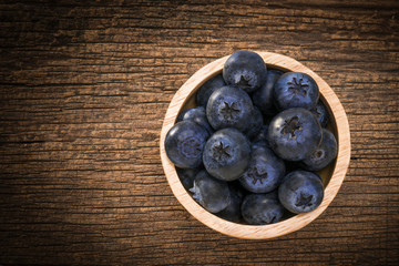 Blueberries in bowl on  on the wooden table, Fresh raw berries  on wood background.