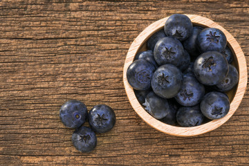 Blueberries in bowl on  on the wooden table, Fresh raw berries  on wood background.