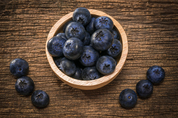 Blueberries in bowl on  on the wooden table, Fresh raw berries  on wood background.