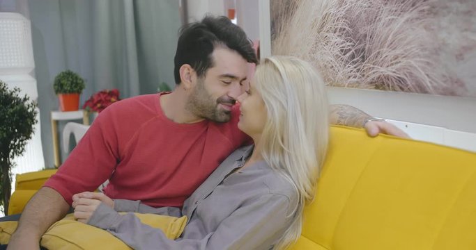 Young positive lovers tenderly touching noses of each other. Couple rubbing noses at romantic moments