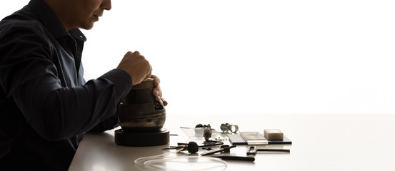 Side view of craftsman engraver  workplace. Various engraver craftsman tools on white desk...