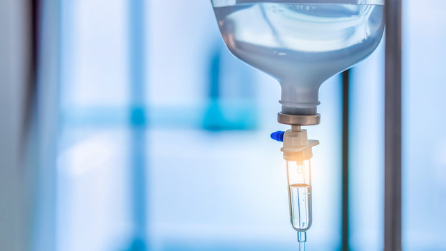 Healthcare concept, Close up of medical drip or IV drip chamber in patient room, Selective focus.