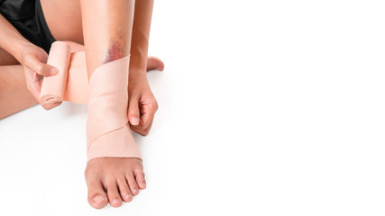 Asian women have bruise on leg from accident and use elastic bandage on her leg, on white...