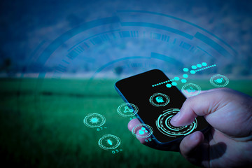 Hand of business man use smart phone in farm, futuristic ai technology, Internet of things, social media and big data concept,  Digital farm analysis and report, hologarphic interface