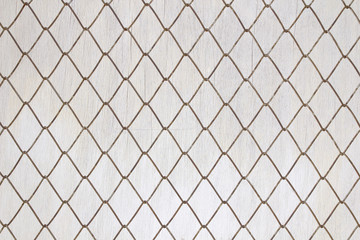 Iron mesh on old white wood background