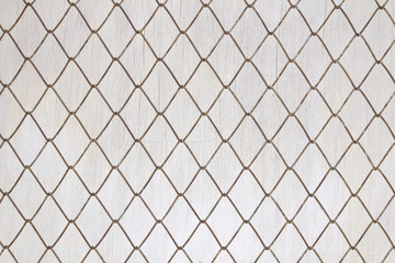 Fototapeta premium Iron mesh on old white wood background