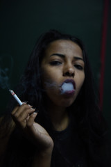 Obraz premium Sexy black woman smoking a cigarette 