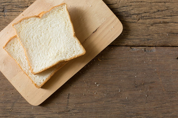Top view of Breakfast bread on a wooden table  with morning sunlight and copy space