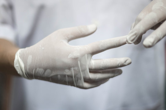 Doctor Female Taking Off Medical Surgical Sterile Gloves