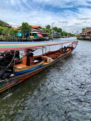 Naklejka na ściany i meble Tourist on narrowboat for a trip to explore local lifestyle along canal in Bangkok