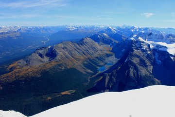 Fototapeta na wymiar View at summit of Mount Temple towards Bow Valley and Trans Canada Highway on the left and Panorama Ridge and Consolation Lake at the center at the center, Banff National Park, Canadian Rockies